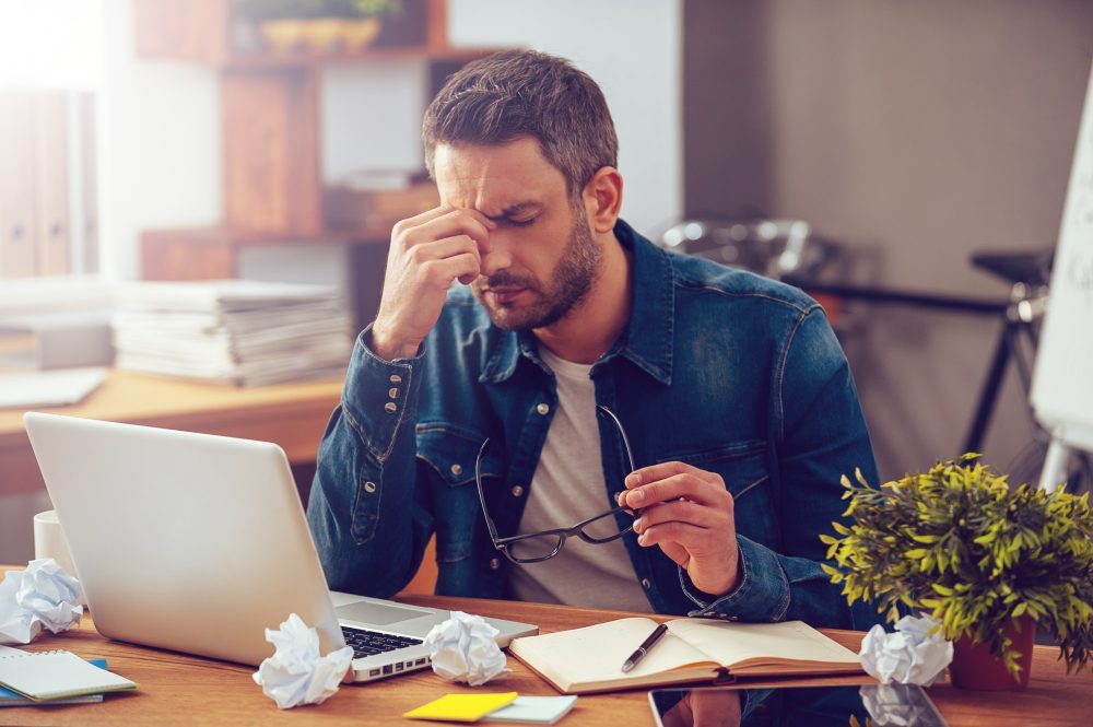 stressed man at laptop